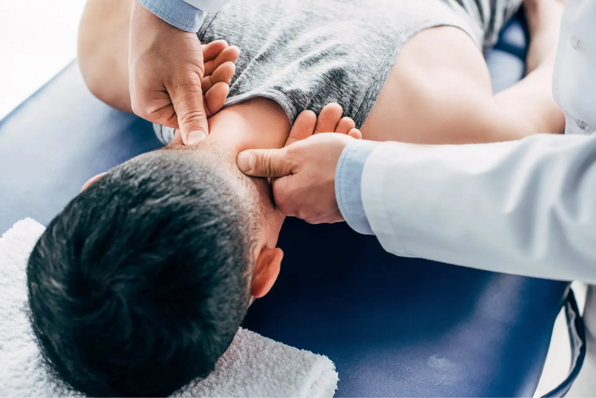 Occupational Health & Ergonomics in Cambridge 2 chiropractor massaging neck of man lying on massag 2022 12 16 19 33 02